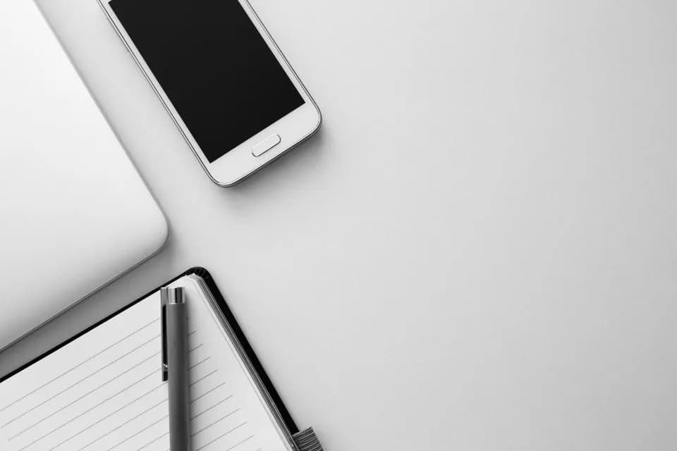 Smartphone and laptop on a desk for cross-platform app development